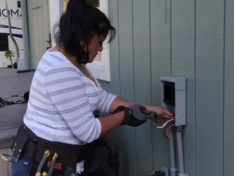 Licensed electrician wiring an exterior subpanel in Antwerp